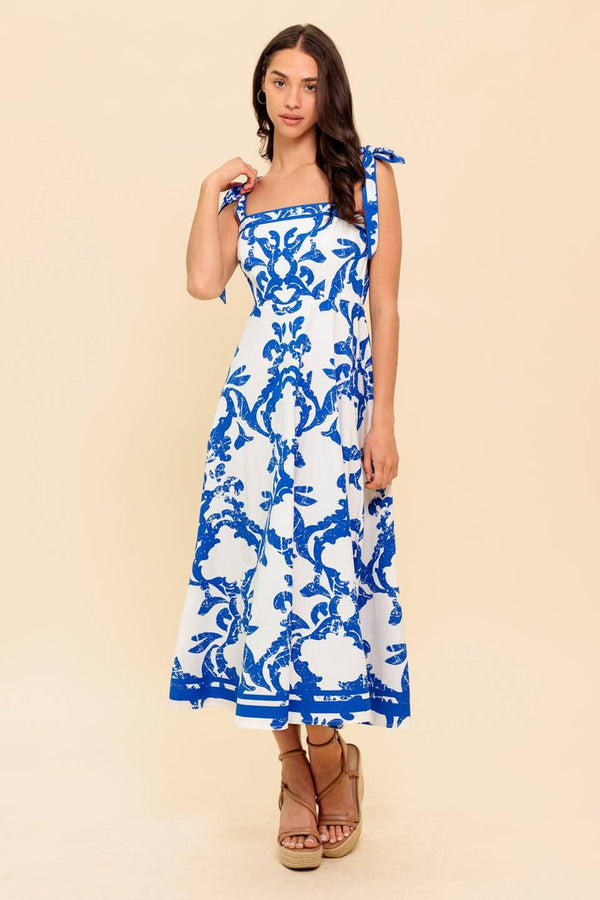 A printed woven midi dress featuring straight neckline, shoulder strap, circle skirt and back zipper closure