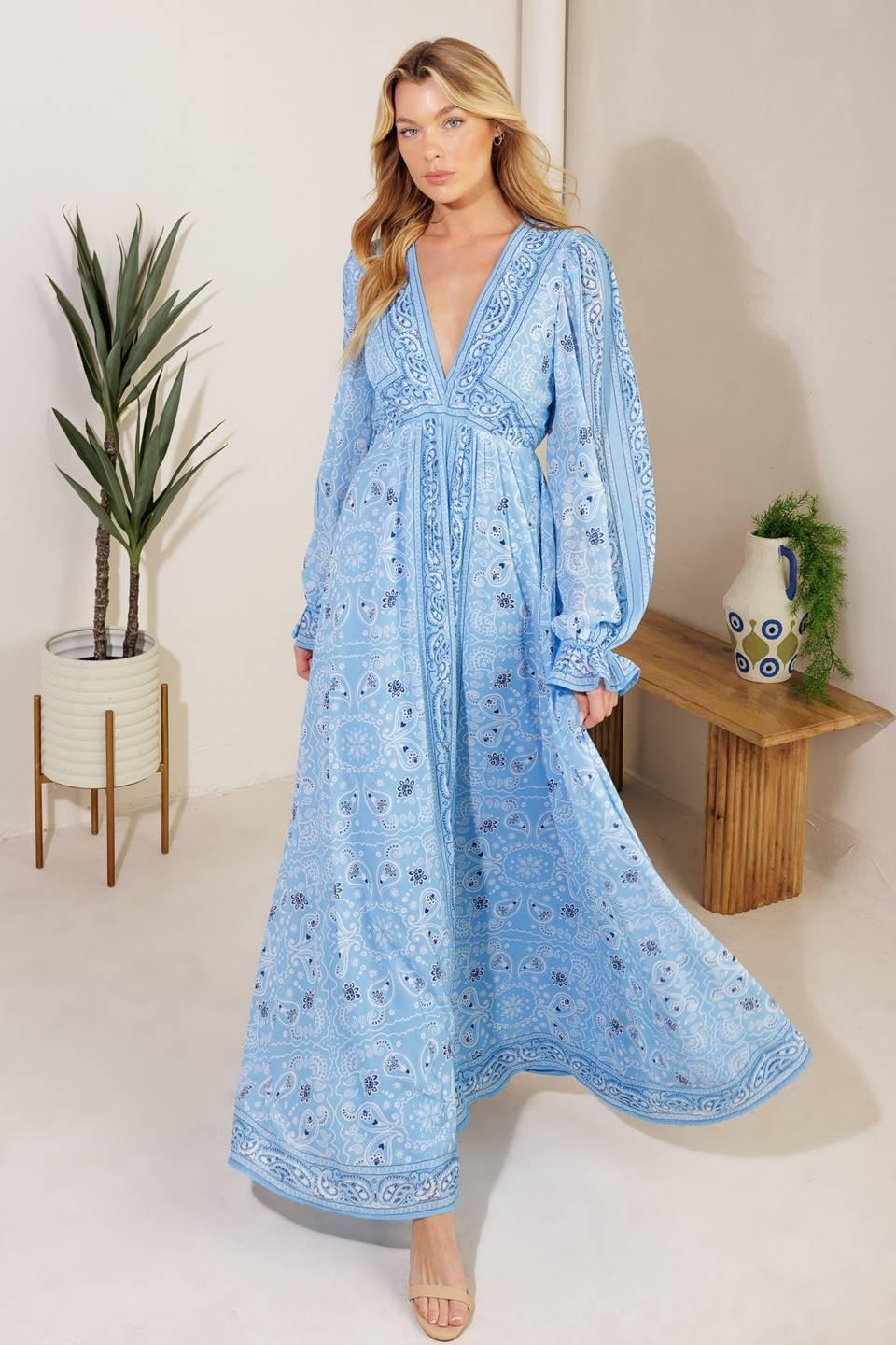 A printed woven maxi dress featuring a V neckline, long sleeve with ruffled cuff, and elasticized waist