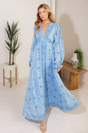 A printed woven maxi dress featuring a V neckline, long sleeve with ruffled cuff, and elasticized waist