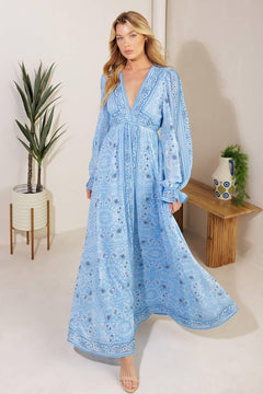 A printed woven maxi dress featuring a V neckline, long sleeve with ruffled cuff, and elasticized waist