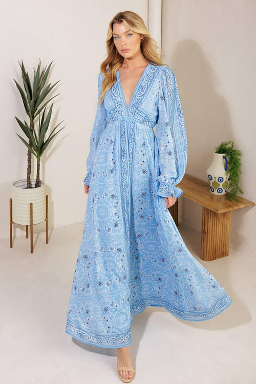 A printed woven maxi dress featuring a V neckline, long sleeve with ruffled cuff, and elasticized waist