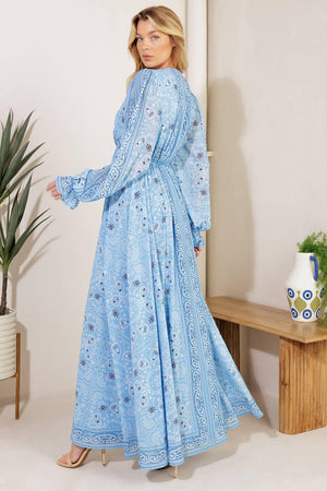 A printed woven maxi dress featuring a V neckline, long sleeve with ruffled cuff, and elasticized waist