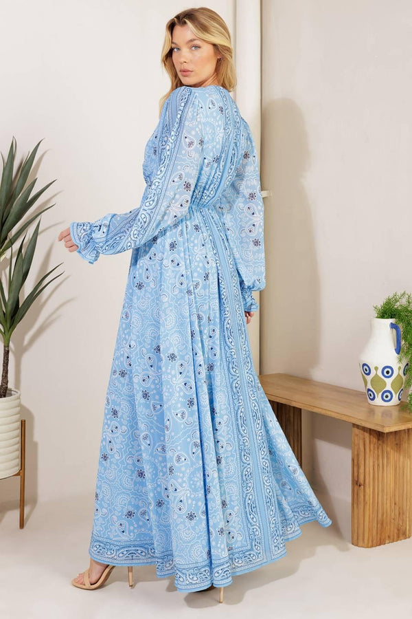 A printed woven maxi dress featuring a V neckline, long sleeve with ruffled cuff, and elasticized waist