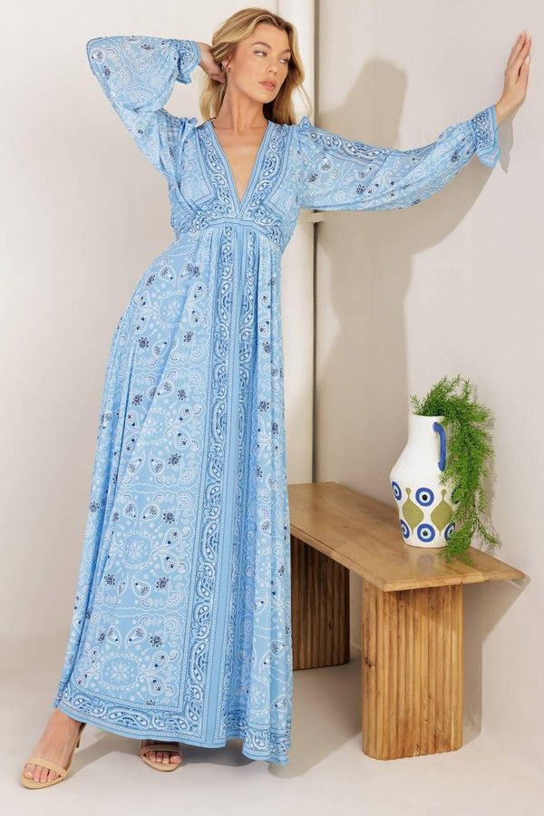 A printed woven maxi dress featuring a V neckline, long sleeve with ruffled cuff, and elasticized waist