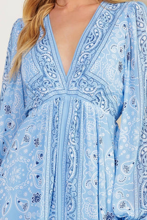 A printed woven maxi dress featuring a V neckline, long sleeve with ruffled cuff, and elasticized waist