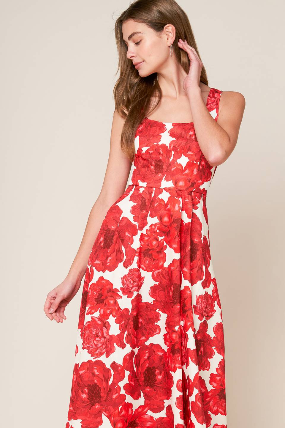 A printed woven midi dress featuring U neckline, sleeveless, full skirt and back zipper closure