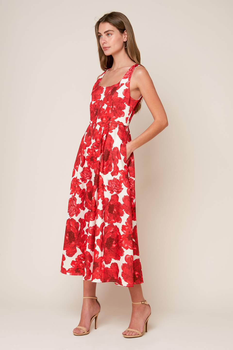 A printed woven midi dress featuring U neckline, sleeveless, full skirt and back zipper closure