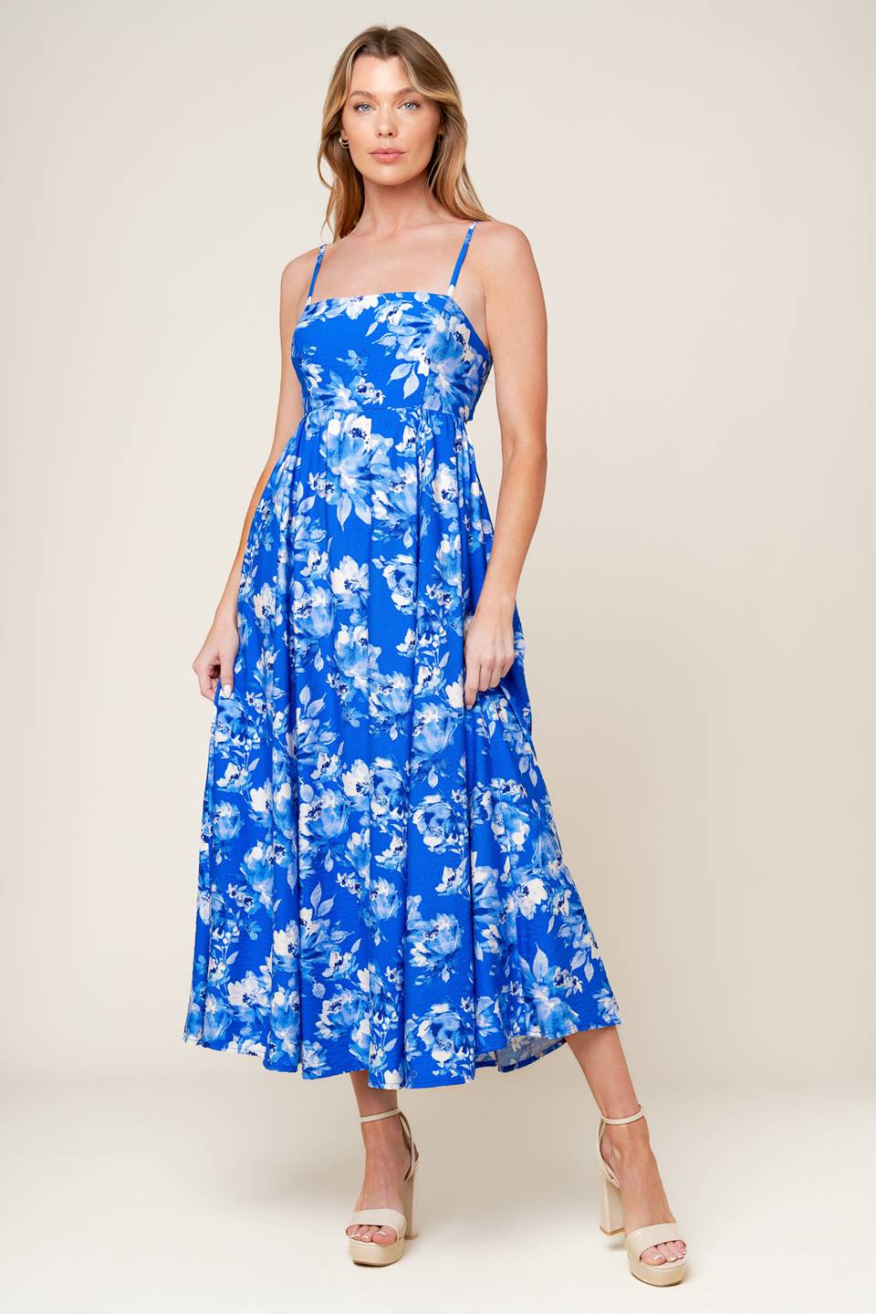 A printed woven midi dress featuring straight neckline, straps, full skirt, back tie and elasticized back