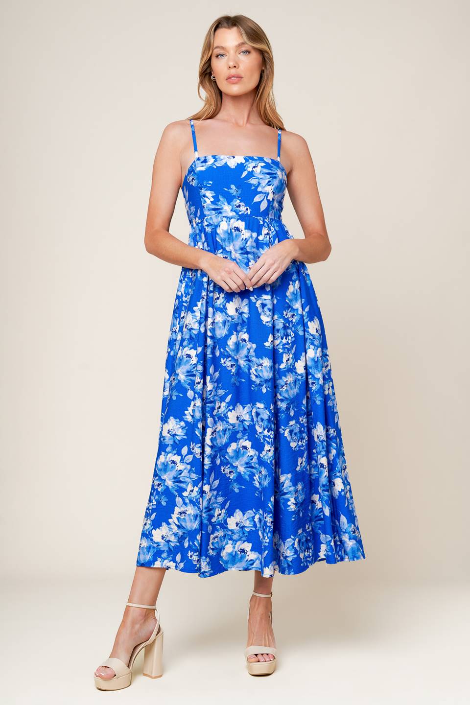 A printed woven midi dress featuring straight neckline, straps, full skirt, back tie and elasticized back