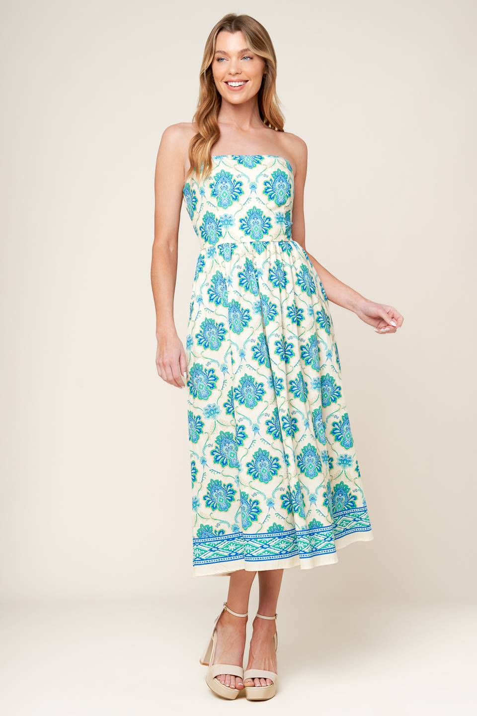 A printed woven midi dress featuring strapless neckline, full skirt and smocked back bodice