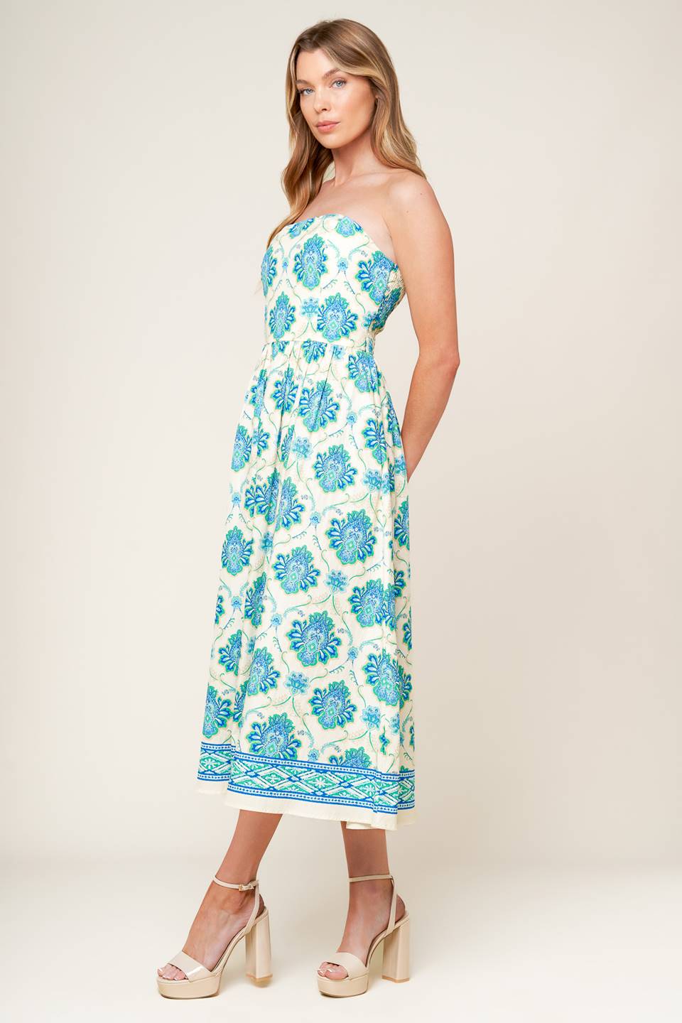 A printed woven midi dress featuring strapless neckline, full skirt and smocked back bodice