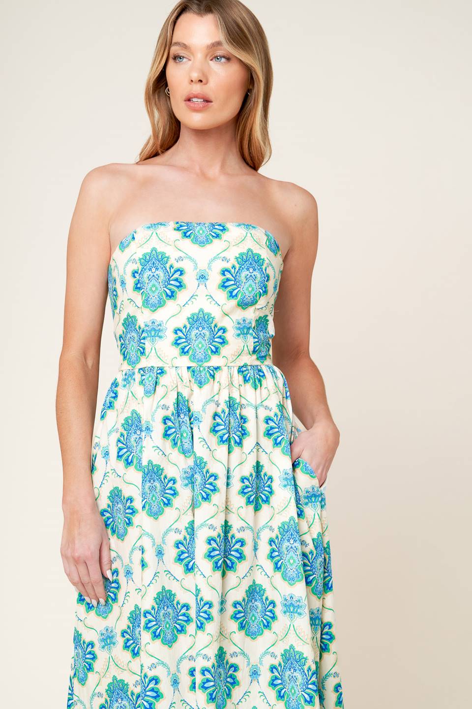 A printed woven midi dress featuring strapless neckline, full skirt and smocked back bodice