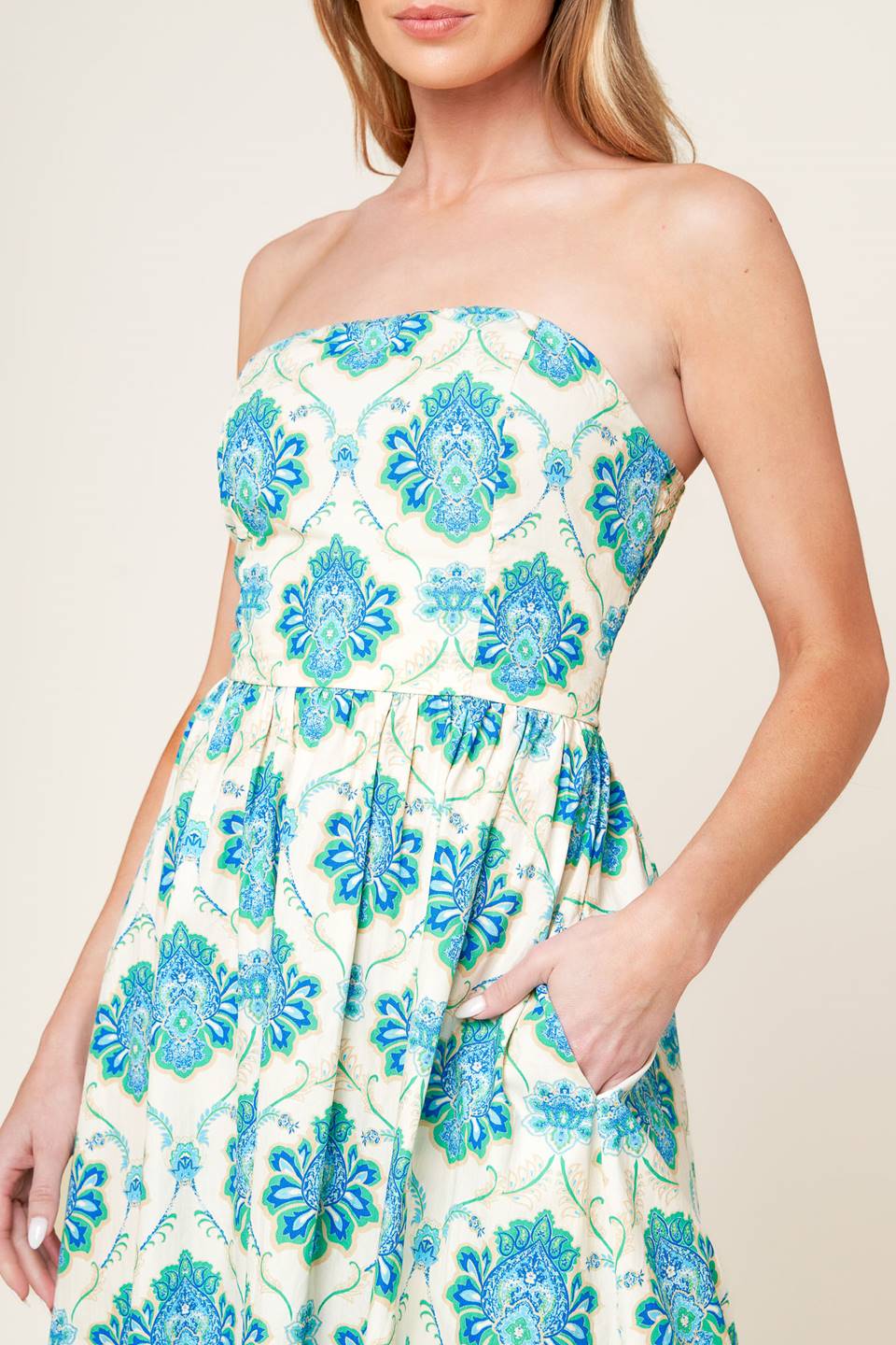 A printed woven midi dress featuring strapless neckline, full skirt and smocked back bodice