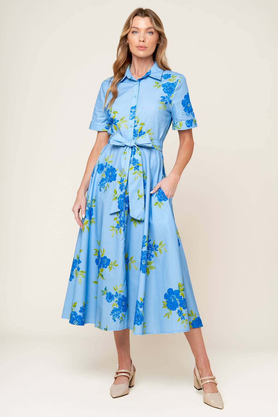 A powder blue printed woven midi dress featuring shirt collar, button down, short sleeves, self sash tie, and full skirt.