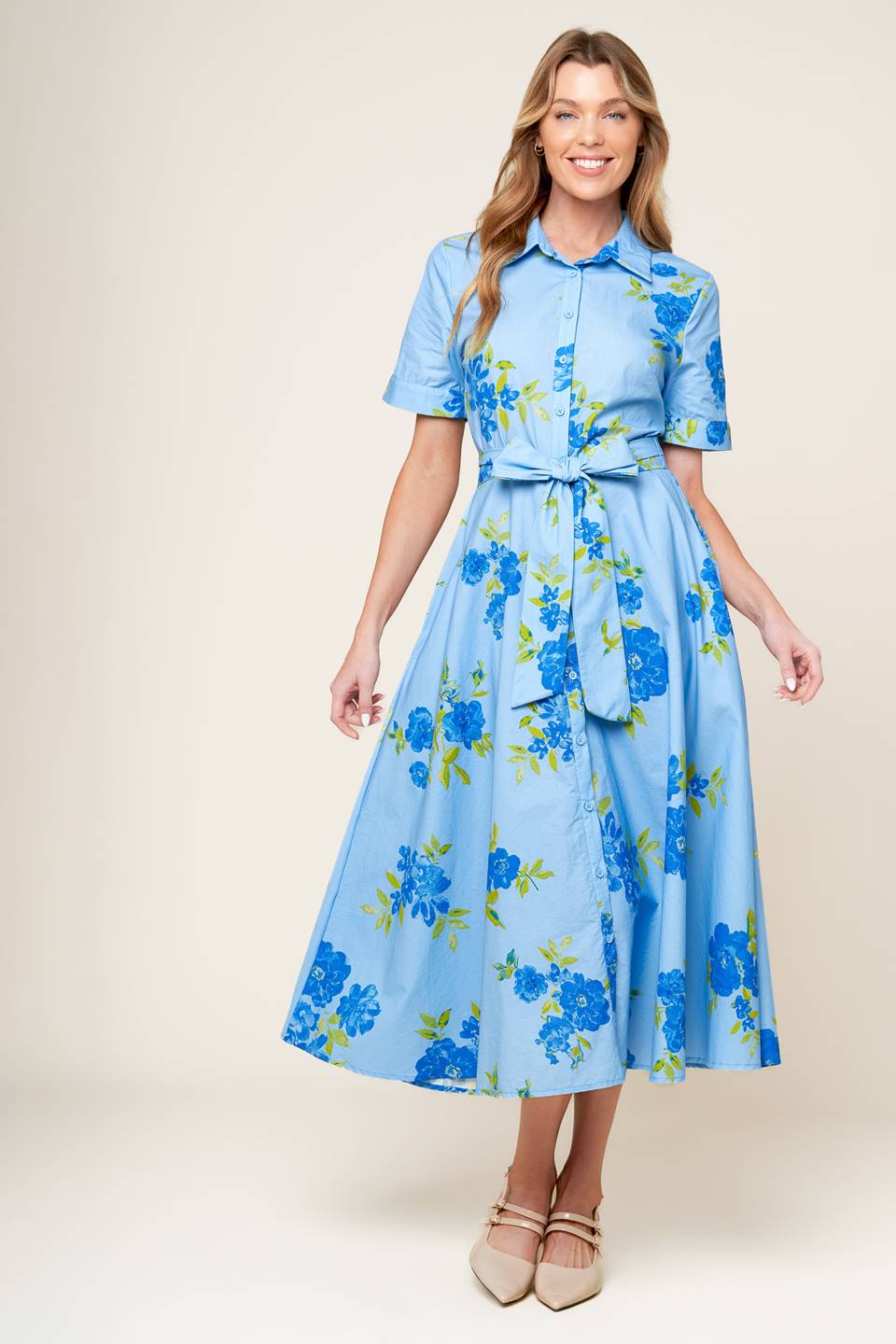 A powder blue printed woven midi dress featuring shirt collar, button down, short sleeves, self sash tie, and full skirt.