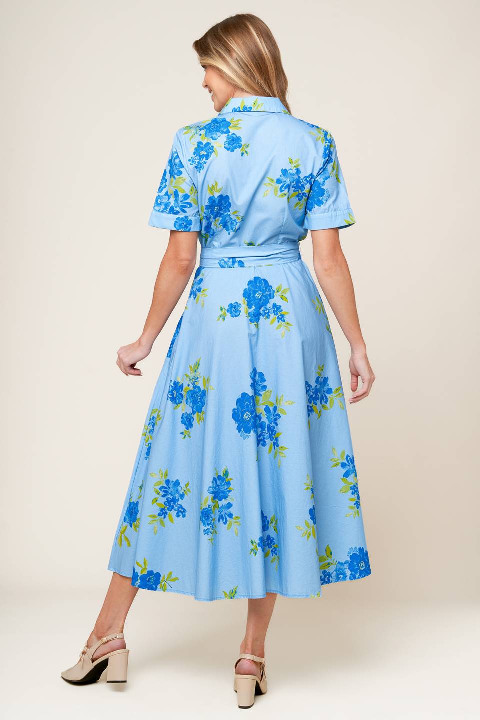 A powder blue printed woven midi dress featuring shirt collar, button down, short sleeves, self sash tie, and full skirt.