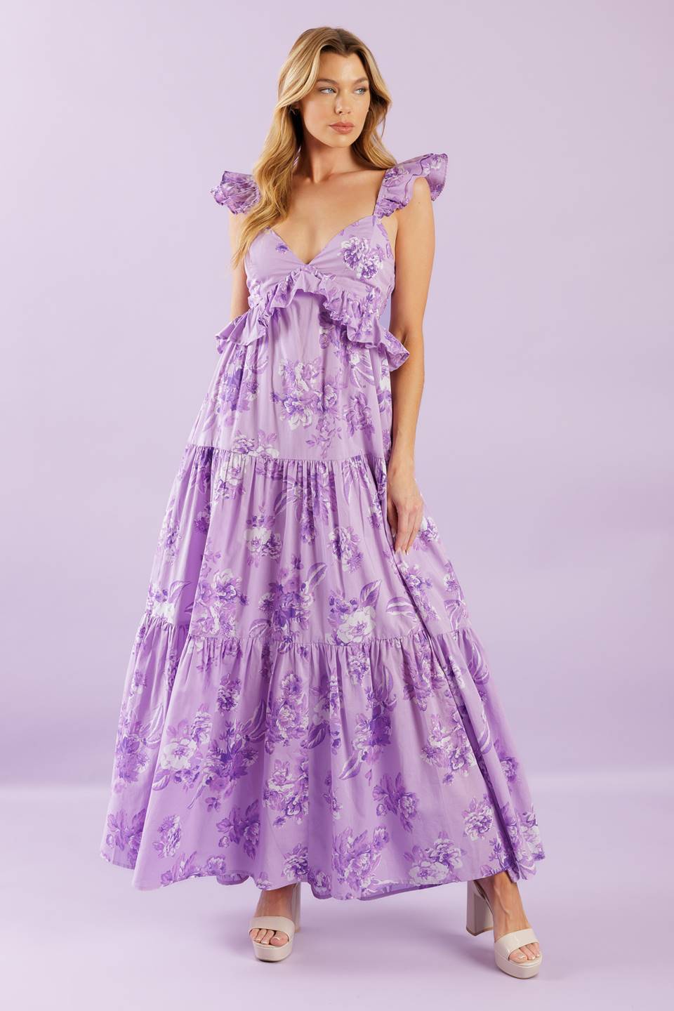 A playful woven maxi dress with a cami-style top, double layered sleeves, and a ruffled empire waist. Its tiered skirt and smocked back bodice add a fun and flowy touch.