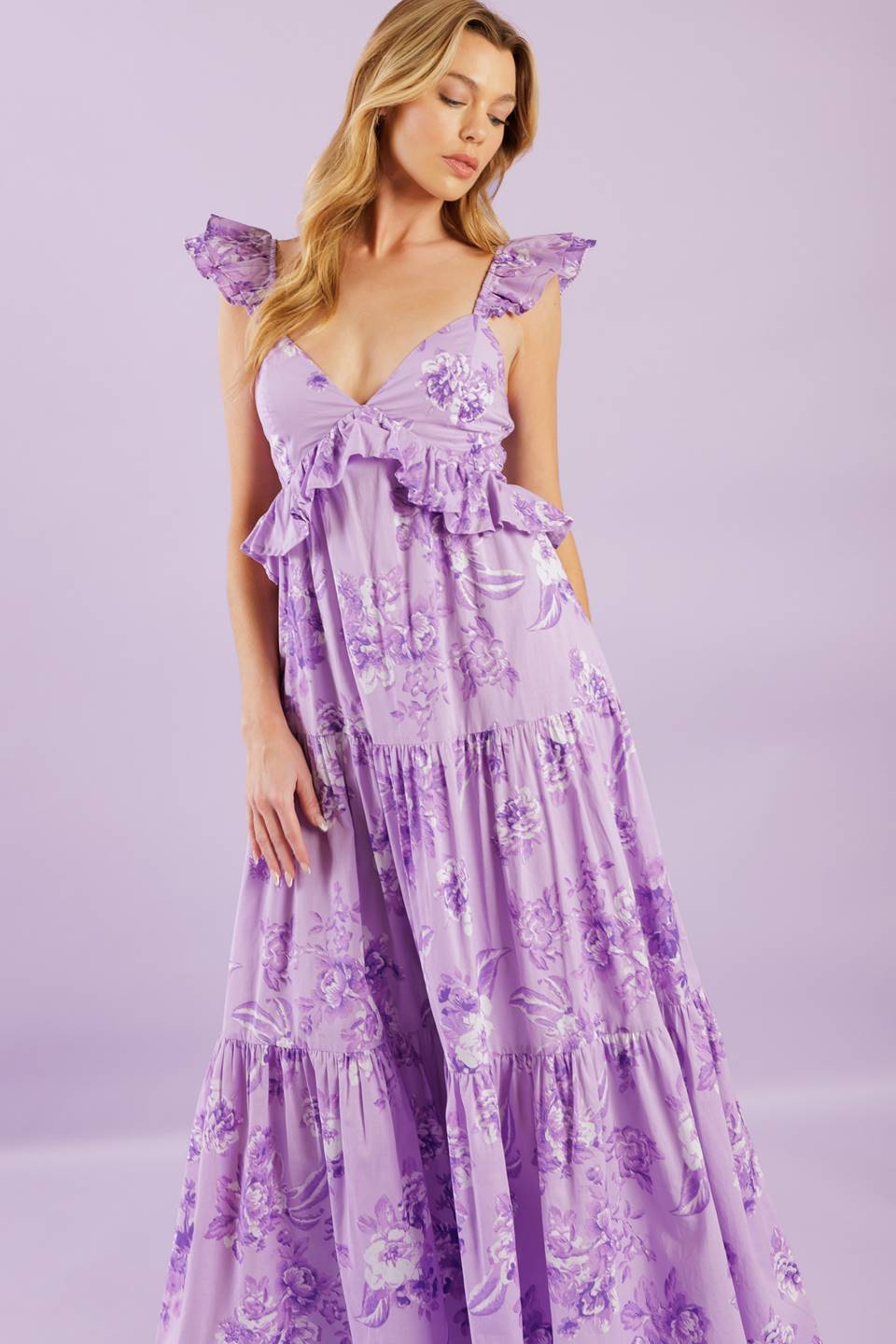 A playful woven maxi dress with a cami-style top, double layered sleeves, and a ruffled empire waist. Its tiered skirt and smocked back bodice add a fun and flowy touch.