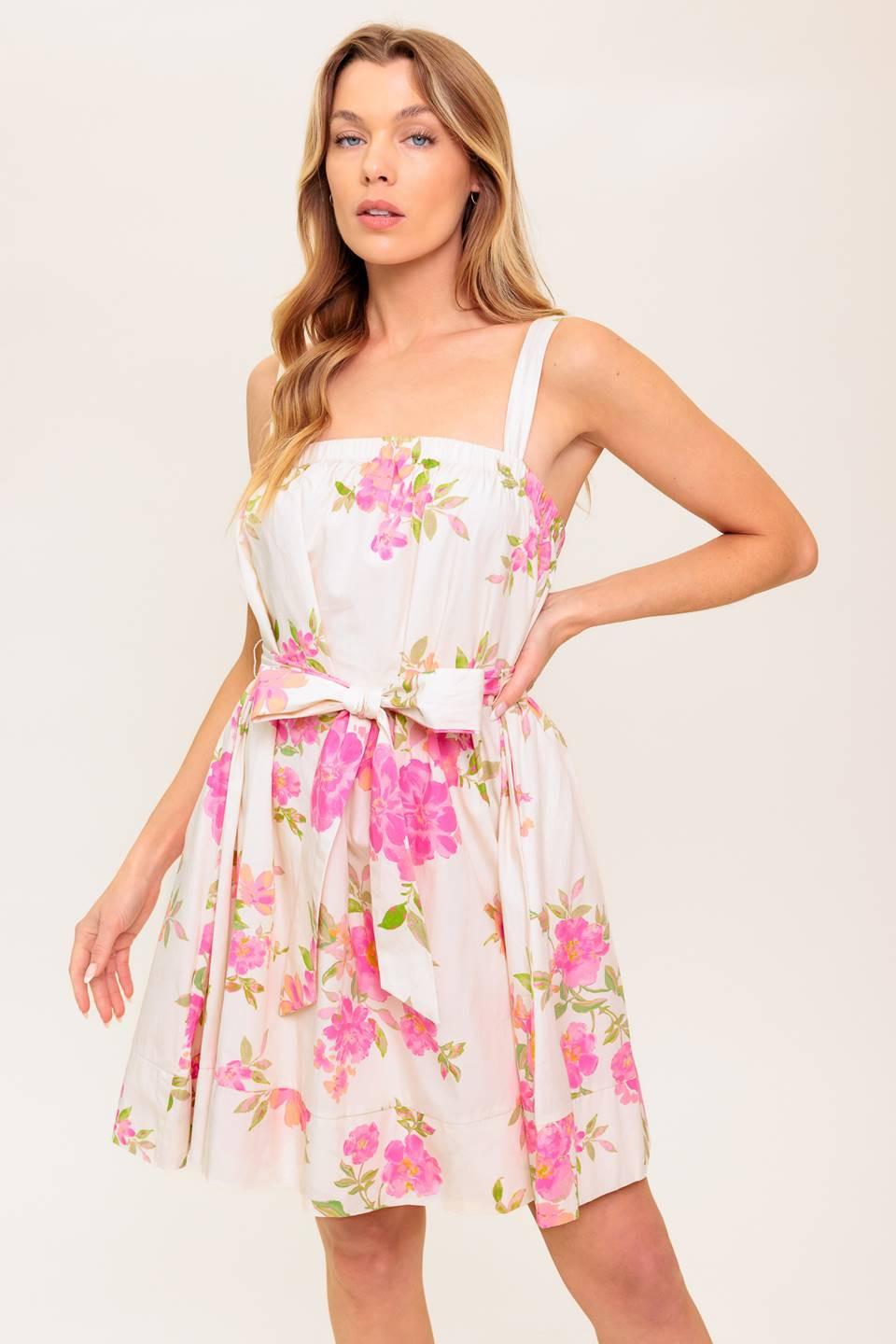 A printed woven mini dress featuring straight neckline, shoulder tie and self sash belt
