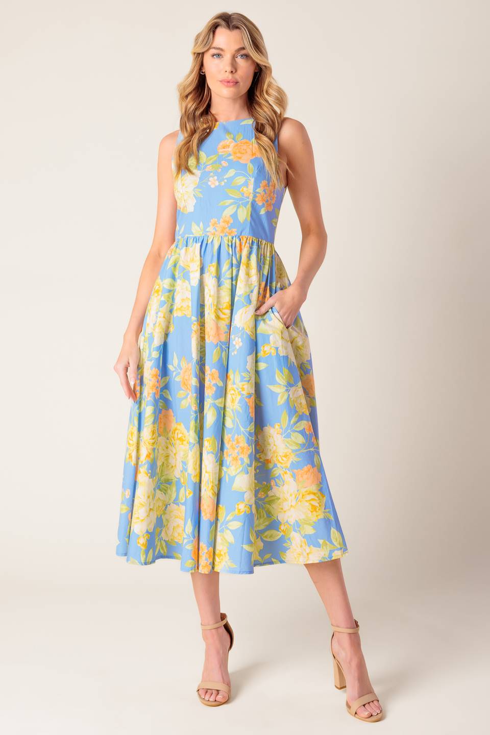 A powder blue floral printed woven midi dress featuring round neckline, sleeveless, full skirt, open back with tie and zipper closure.