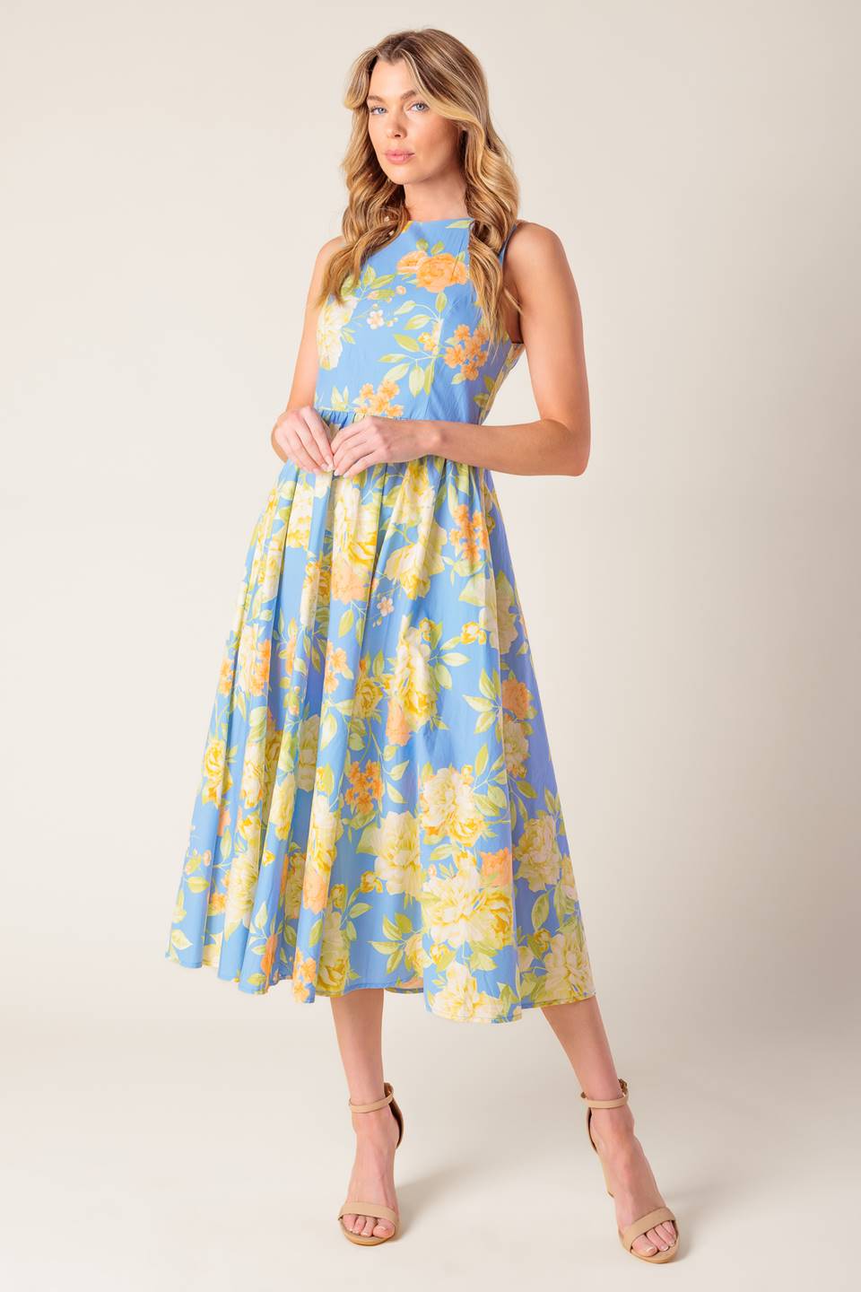 A powder blue floral printed woven midi dress featuring round neckline, sleeveless, full skirt, open back with tie and zipper closure.