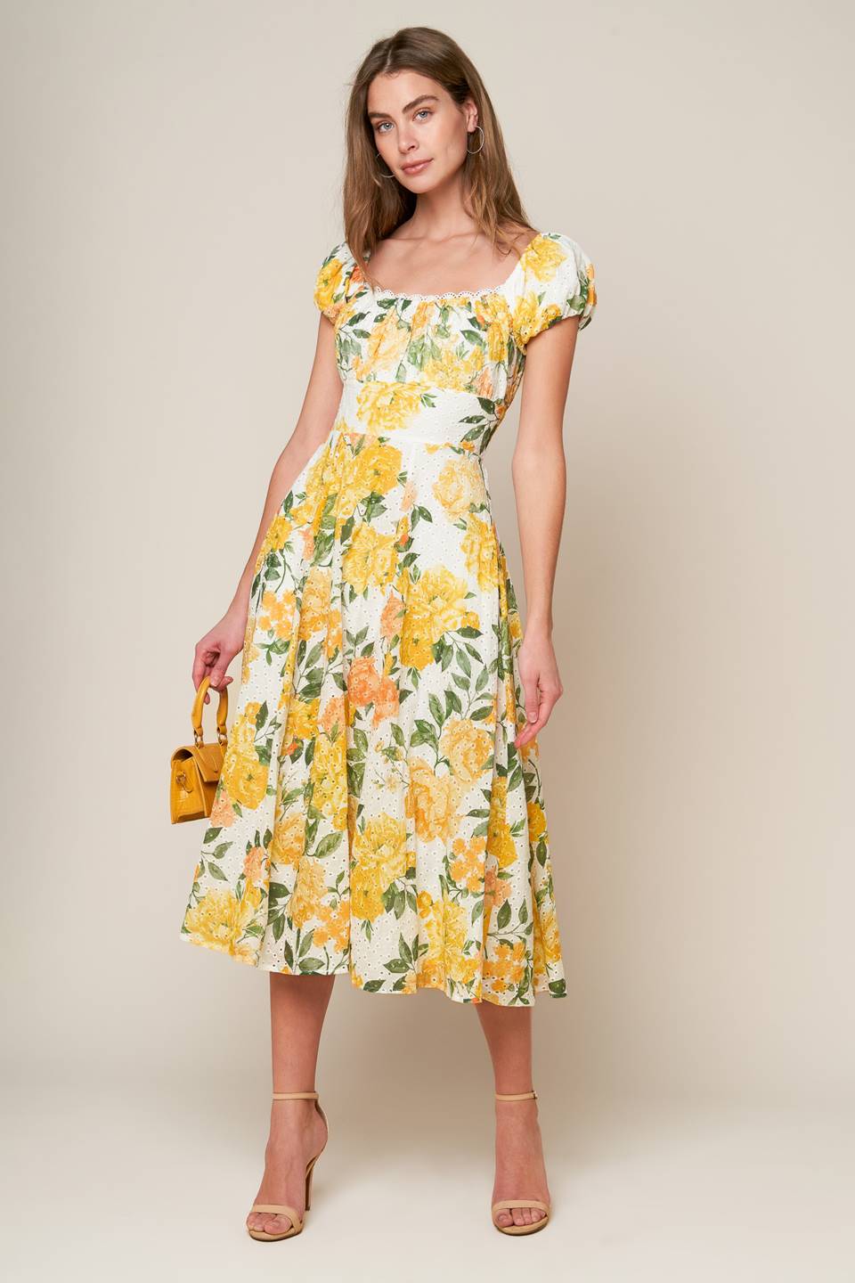 A woven printed eyelet dress featuring square neckline, short sleeve, full skirt and smocked back bodice