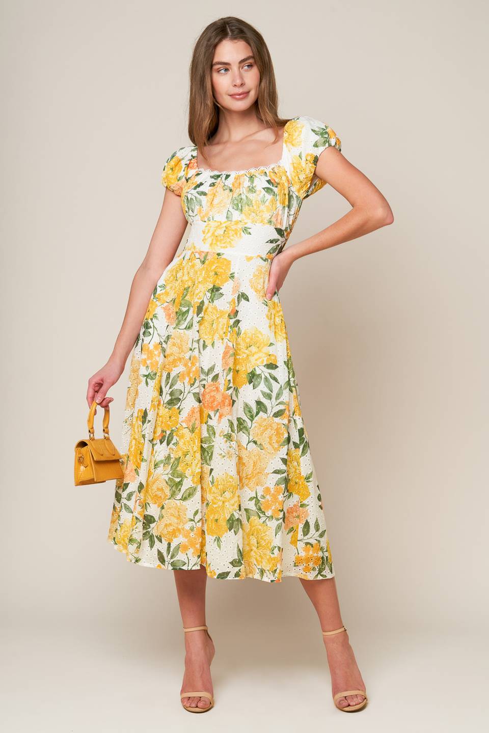 A woven printed eyelet dress featuring square neckline, short sleeve, full skirt and smocked back bodice