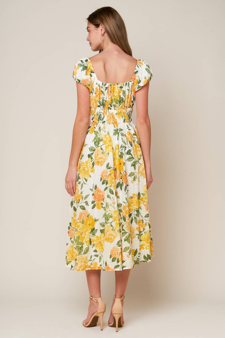 A woven printed eyelet dress featuring square neckline, short sleeve, full skirt and smocked back bodice