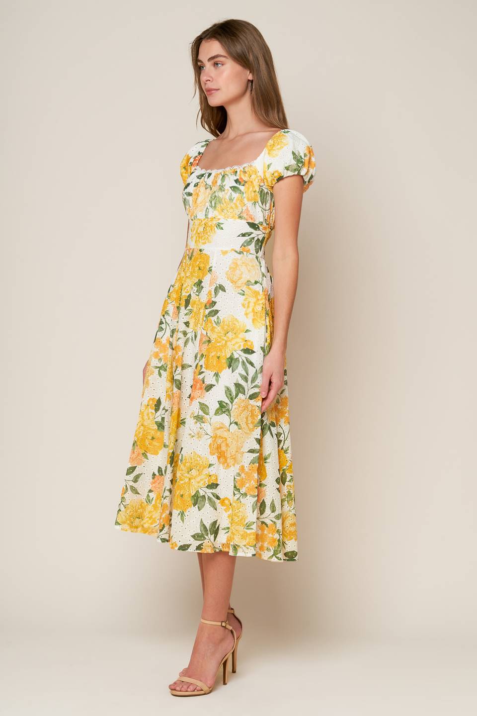 A woven printed eyelet dress featuring square neckline, short sleeve, full skirt and smocked back bodice