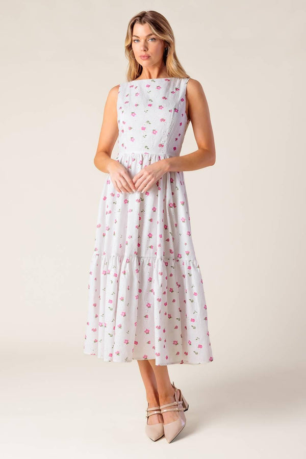 A printed woven eyelet midi dress featuring round neckline, sleeveless, ruffled hem, U back with tie and zipper closure