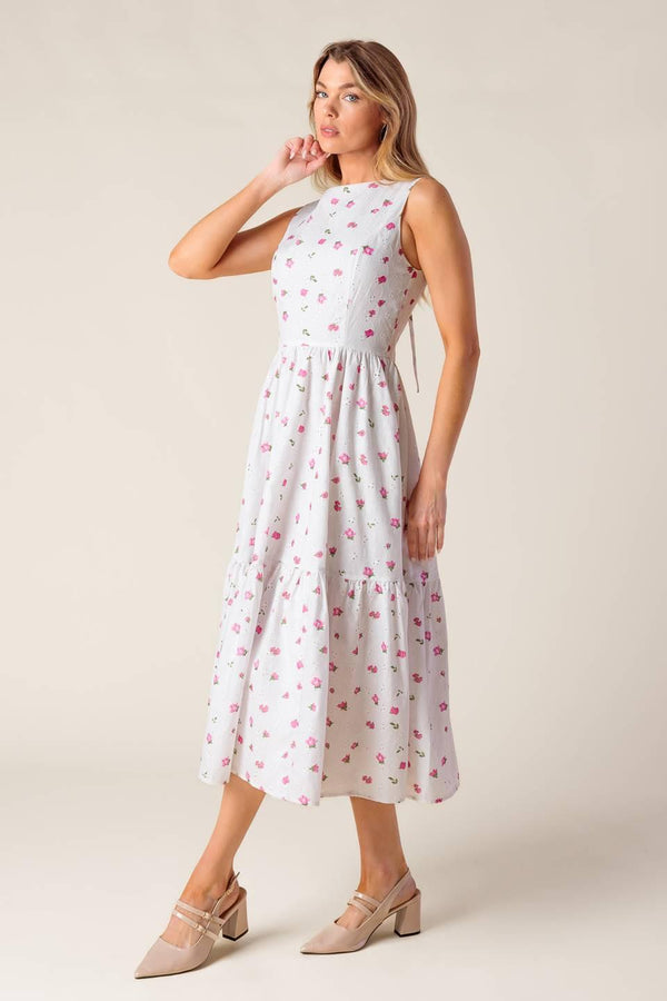 A printed woven eyelet midi dress featuring round neckline, sleeveless, ruffled hem, U back with tie and zipper closure