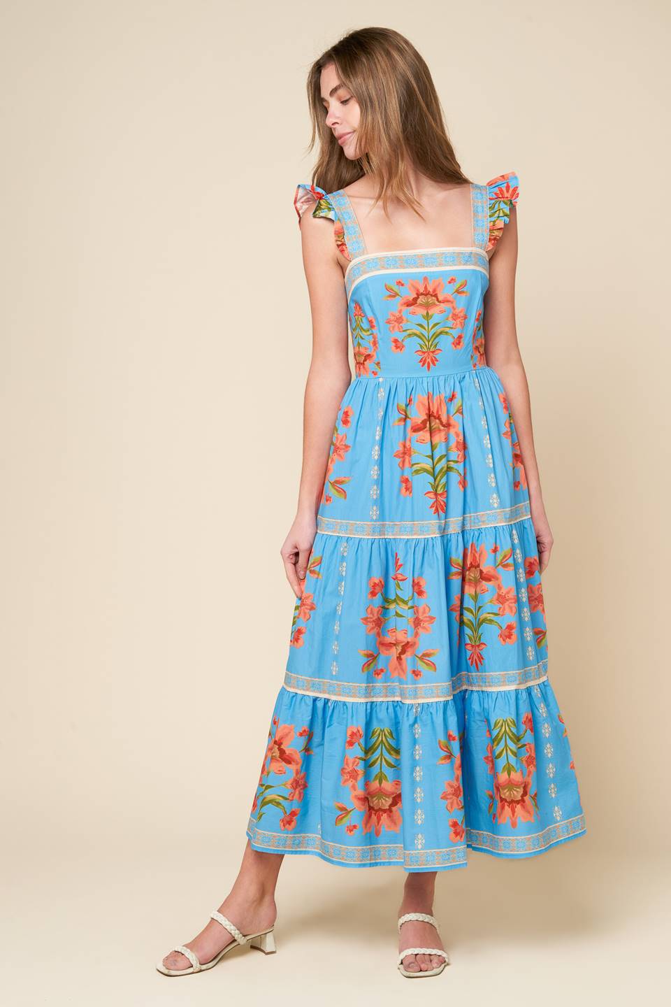 midi dress that's perfect for your whimsical side - featuring a printed woven fabric, a square neckline, short ruffled sleeves, a tiered skirt, and a smocked back bodice.