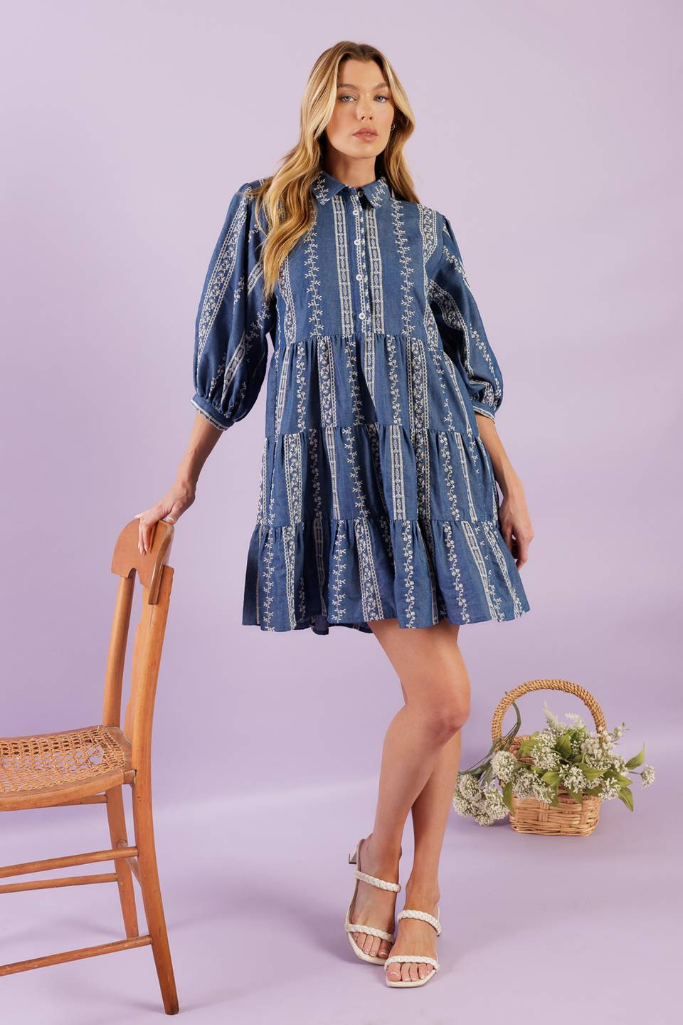 A woven embroidered fabric mini dress featuring collar, button down at bodice, 3/4 sleeve and tiered skirt