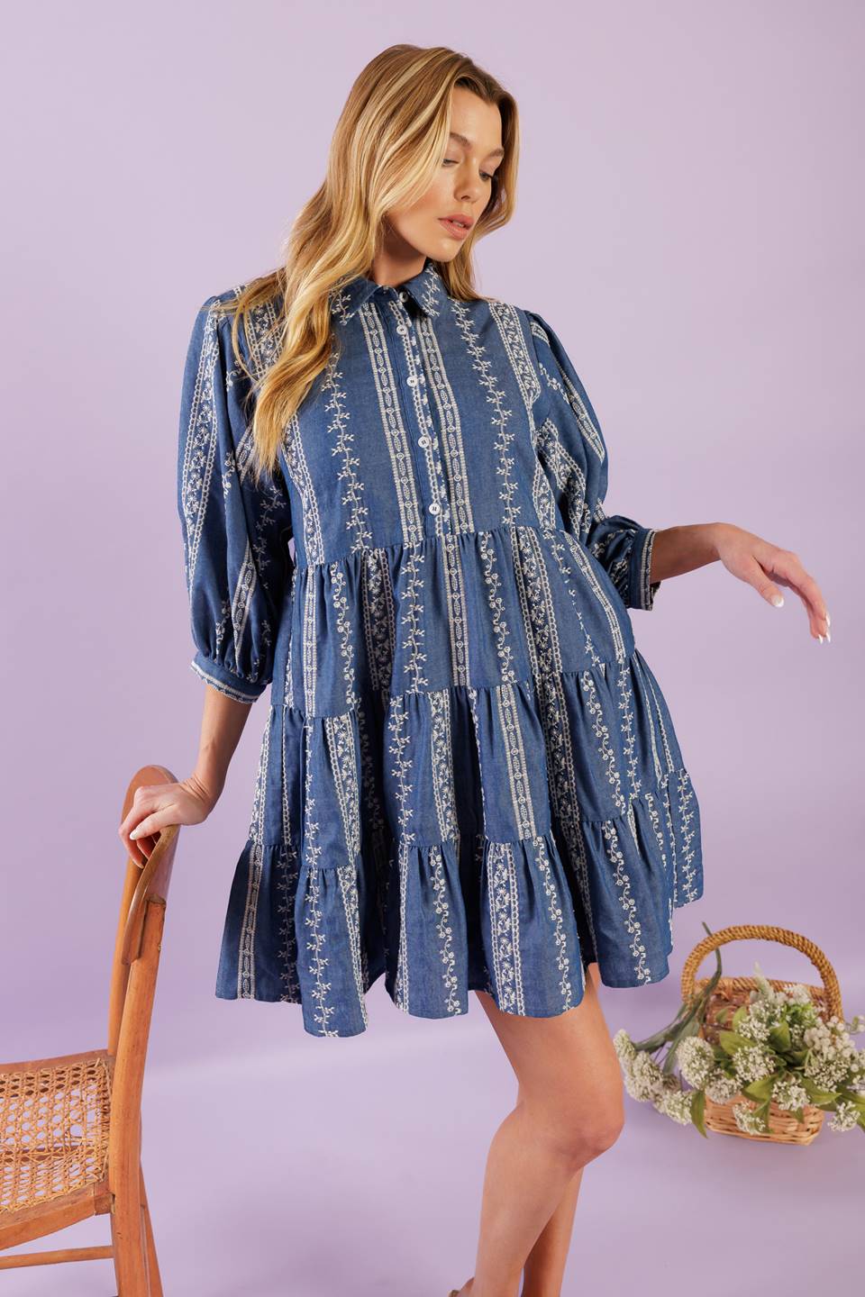 A woven embroidered fabric mini dress featuring collar, button down at bodice, 3/4 sleeve and tiered skirt