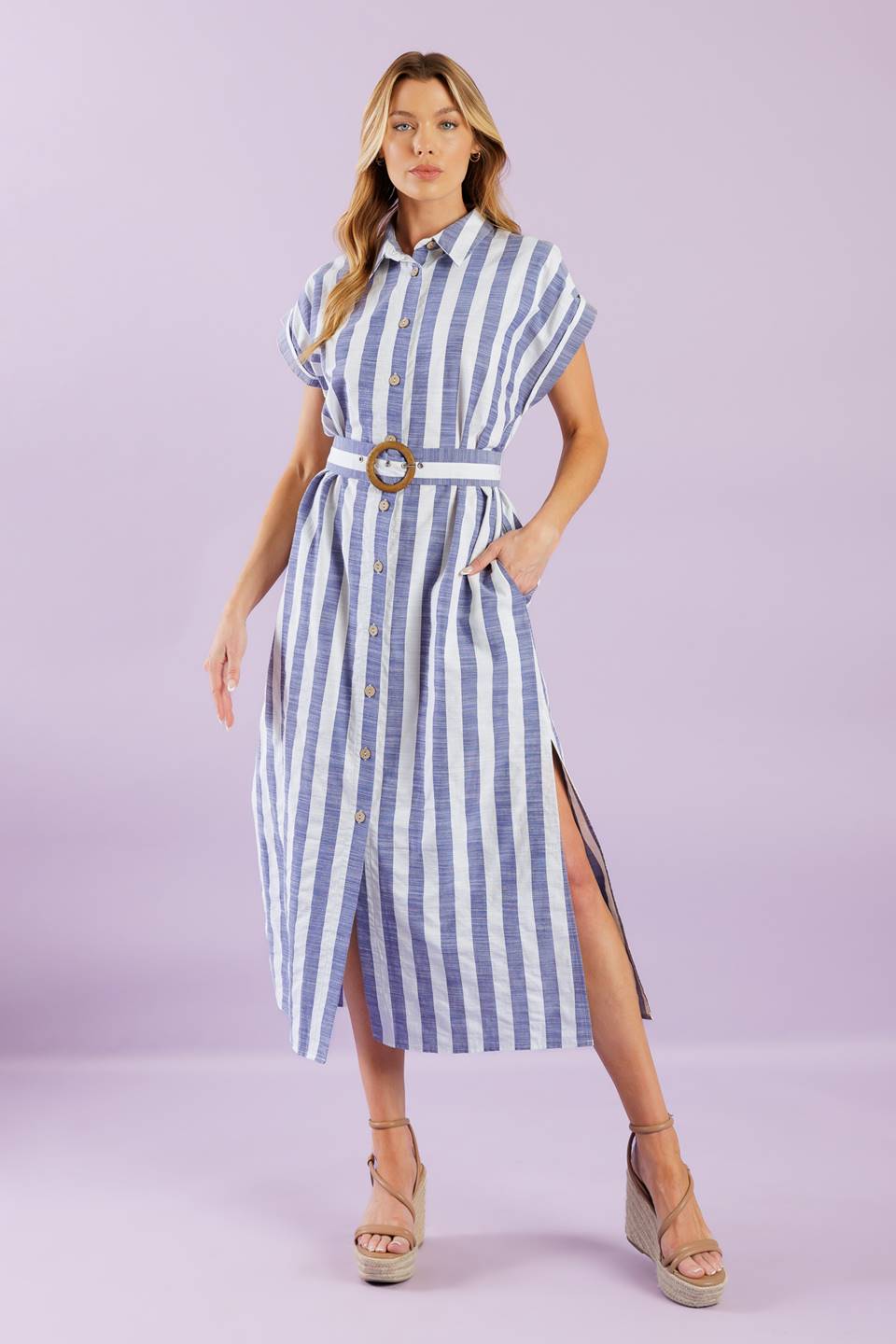 A vacay-ready woven midi dress with stripes, collar, button down, cuffed sleeves, a belted waist, and convenient side pockets.