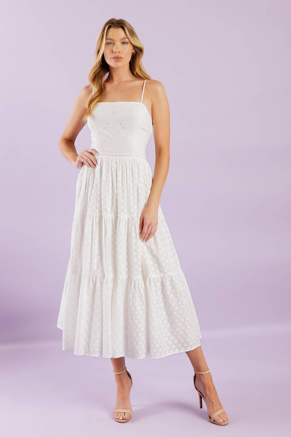 A solid woven midi dress featuring straight neckline with straps, embroidered bodice, textured tiered skirt and smocked back bodice