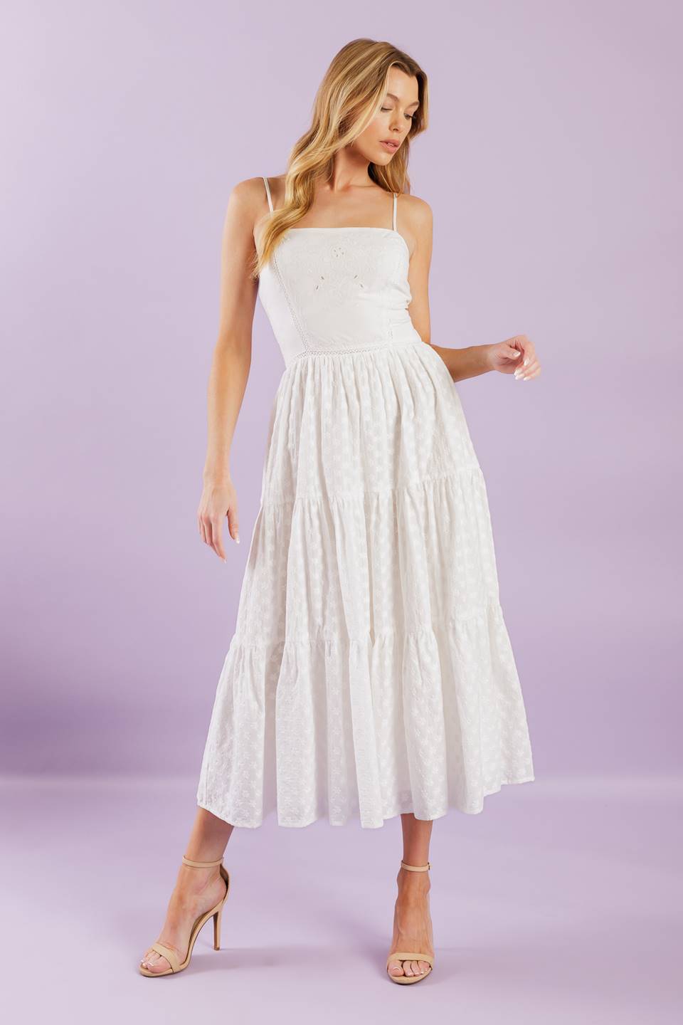 A solid woven midi dress featuring straight neckline with straps, embroidered bodice, textured tiered skirt and smocked back bodice