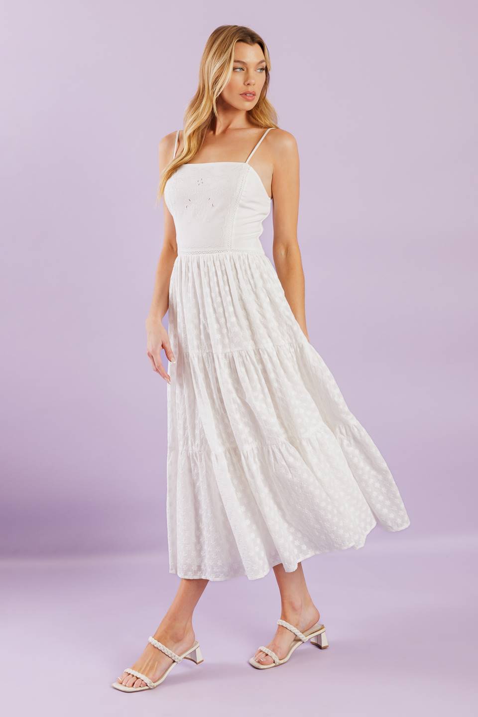 A solid woven midi dress featuring straight neckline with straps, embroidered bodice, textured tiered skirt and smocked back bodice