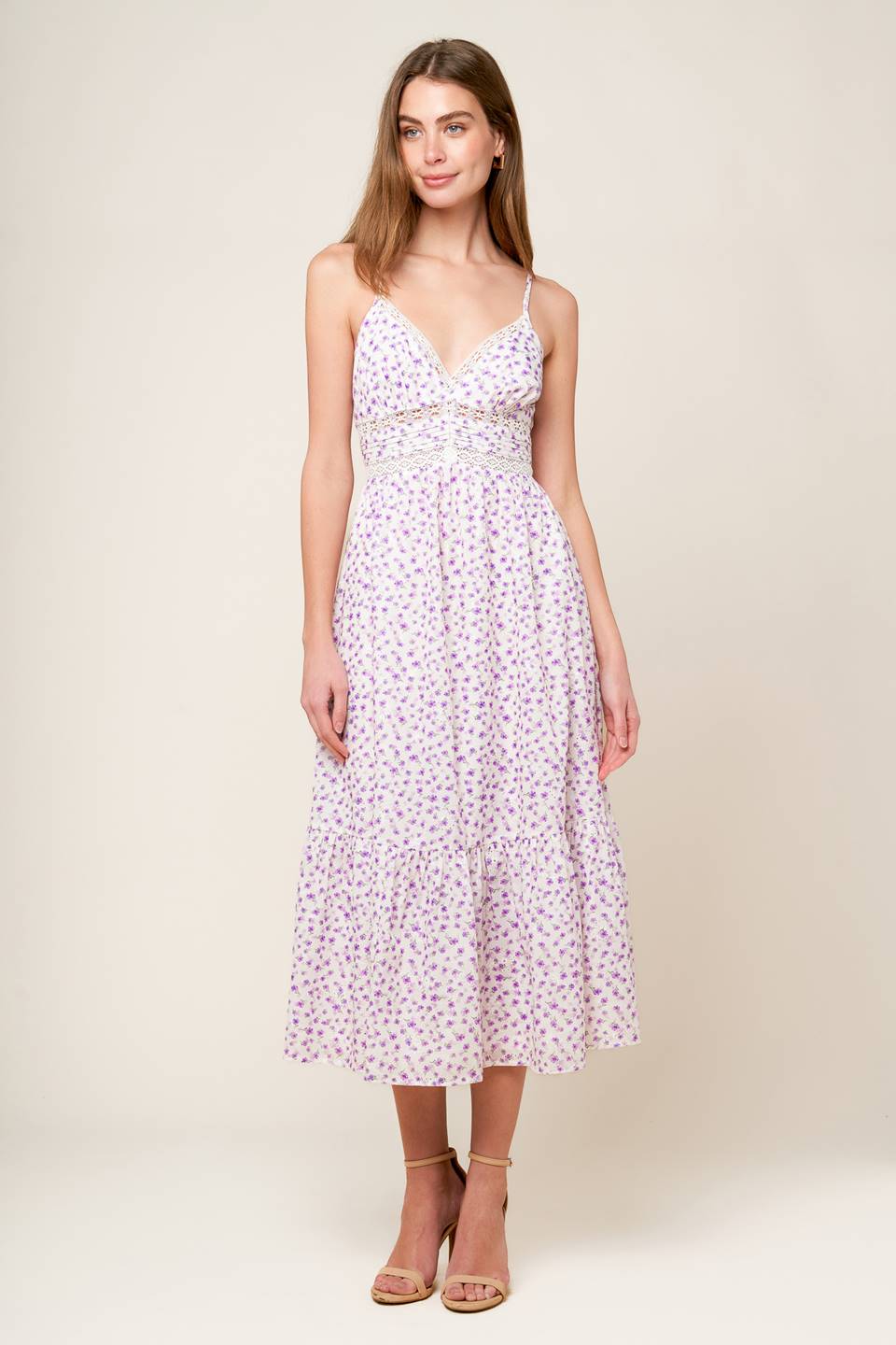 A white and lavender floral printed woven midi dress featuring cami top with straps, pleated waist band with lace inset, ruffled hemline and smocked back waistband.