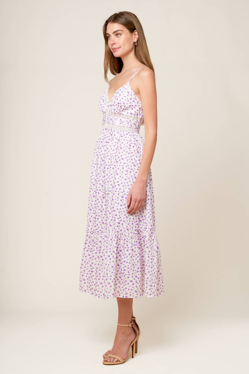 A white and lavender floral printed woven midi dress featuring cami top with straps, pleated waist band with lace inset, ruffled hemline and smocked back waistband.