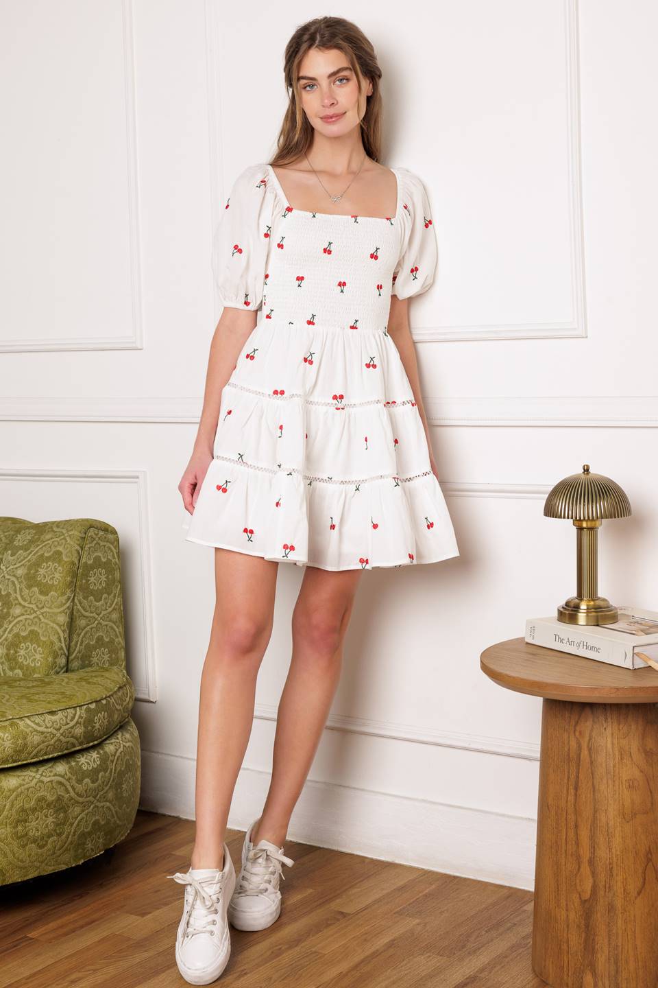 A cute embroidered mini dress with a square neckline, short puff sleeves, smocked bodice and a tiered skirt with lace detailing.