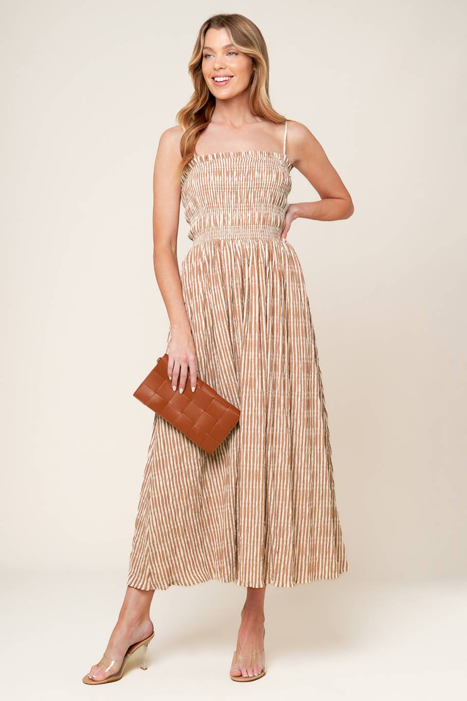 A striped woven midi dress featuring straight neckline with ruffled edge, straps and full skirt