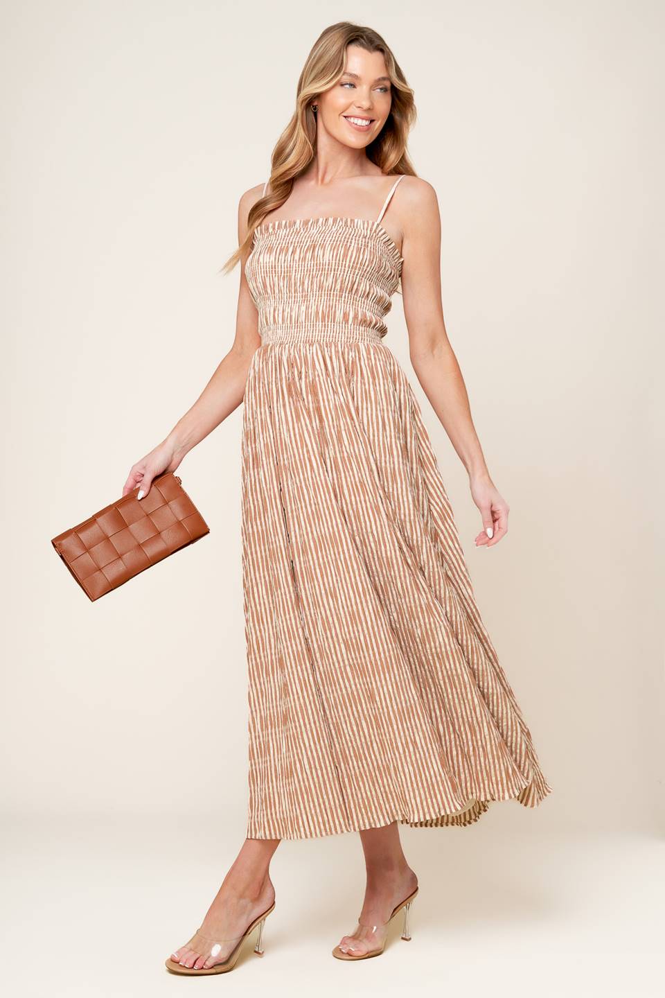 A striped woven midi dress featuring straight neckline with ruffled edge, straps and full skirt