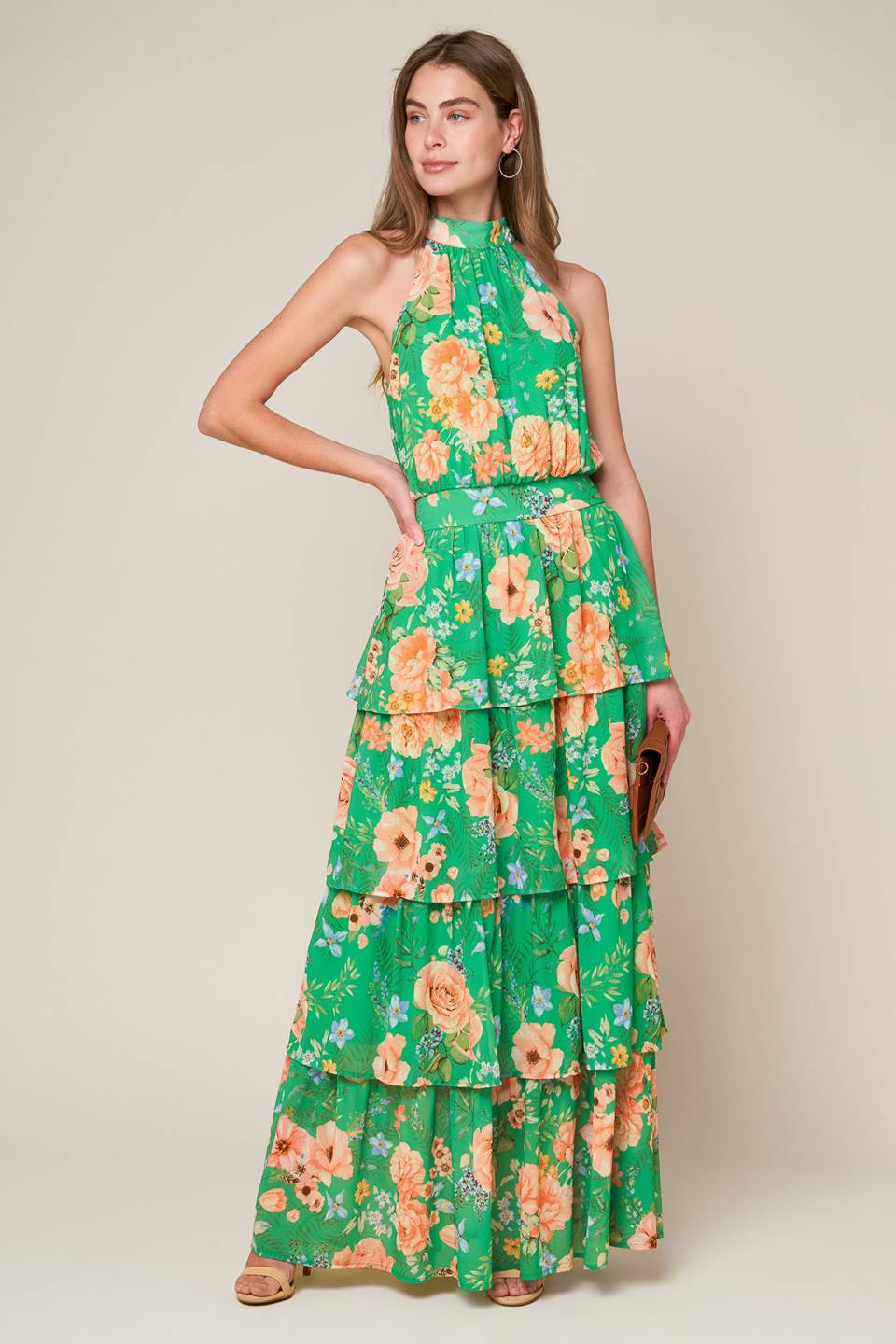 A printed woven maxi dress featuring halter neckline, sleeveless, layered skirt, back neck tie and smocked back waistband