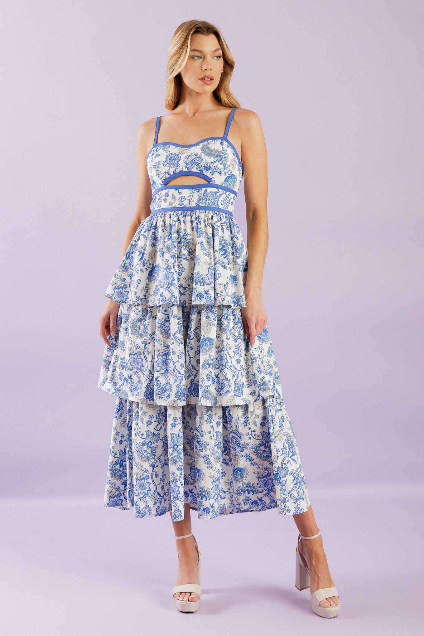 A printed woven midi dress featuring sweetheart neckline, straps, front bodice cut out, layered skirt and back zipper closure