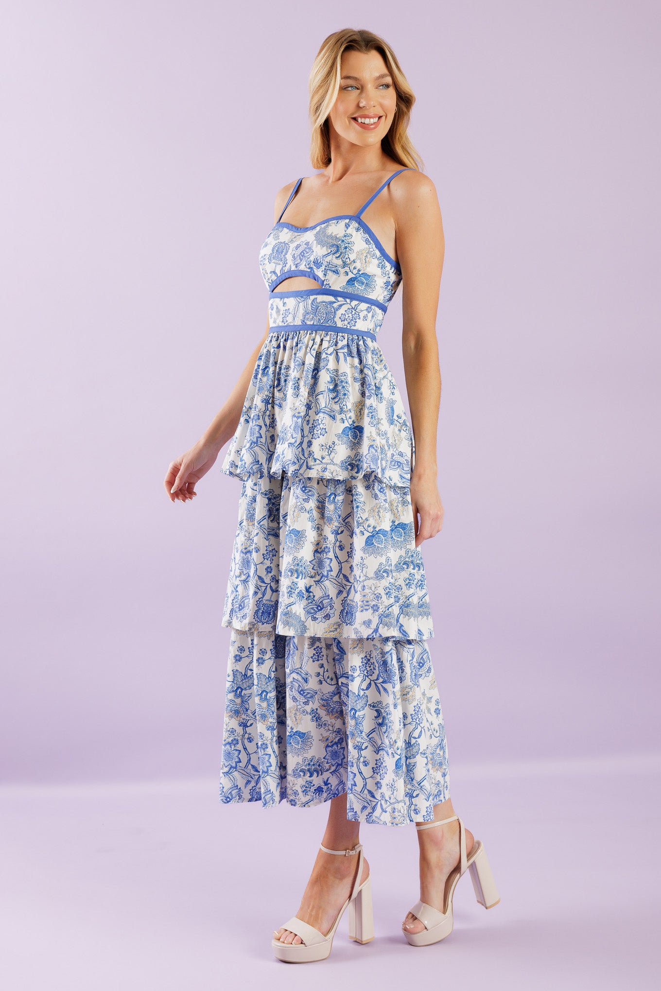 A printed woven midi dress featuring sweetheart neckline, straps, front bodice cut out, layered skirt and back zipper closure