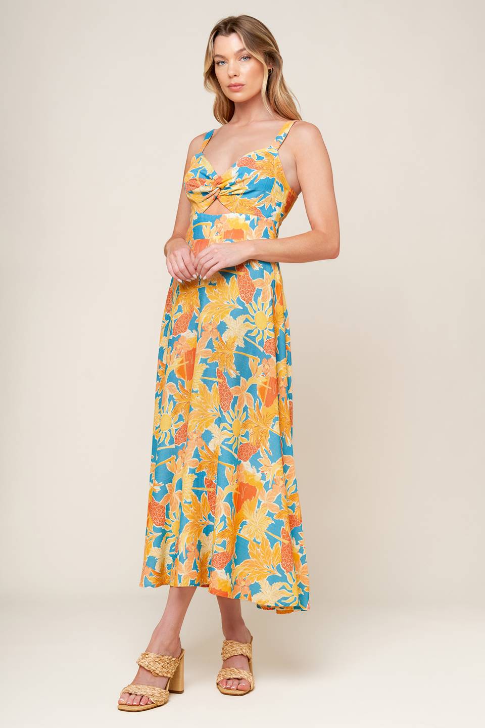 A printed woven midi dress featuring sweetheart neckline with twisted bodice detail, front cut out, straps, A line skirt and back zipper closure.