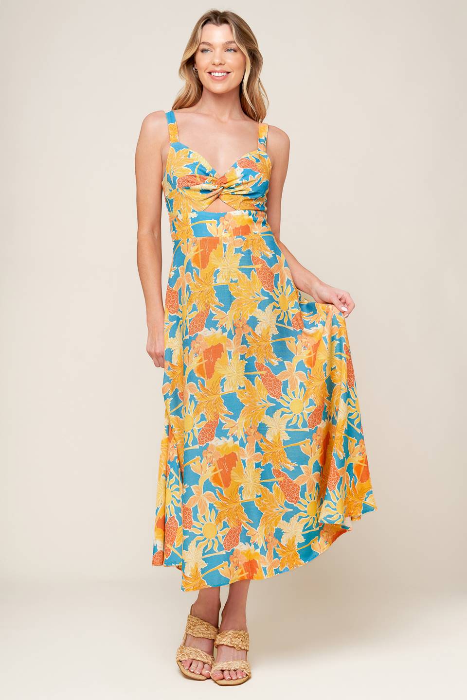 A printed woven midi dress featuring sweetheart neckline with twisted bodice detail, front cut out, straps, A line skirt and back zipper closure.