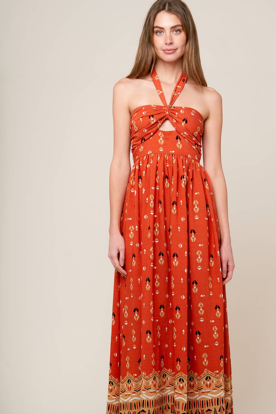 A printed woven maxi dress featuring halter neckline, center front cut out, wide waistband and smocked back bodies.