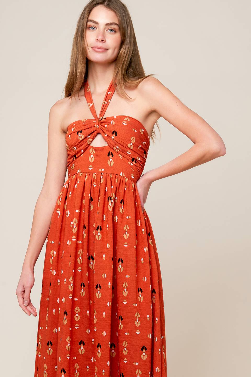 A printed woven maxi dress featuring halter neckline, center front cut out, wide waistband and smocked back bodies.